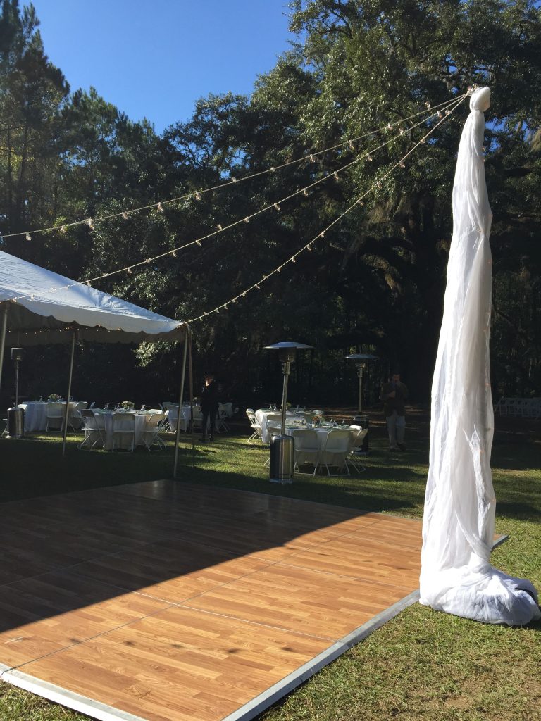 Reception all setup for Brian and Julie's Lichgate on High Rd wedding. Outdoor dance floor, white lights, heaters, and fun!